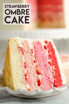 a slice of red, white and blue cake on a plate with another piece in the background