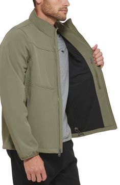 Layer your look with a soft shell jacket made from a water-resistant fabric that's outfitted with three zip-secured pockets to stash your gear. 28 1/2" length (size Medium) Water resistant Front zip closure 2 front zip pockets, 1 interior zip pocket 93% polyester, 7% spandex Machine wash, tumble dry Imported Practical Khaki Outerwear For Hiking, Khaki Outdoor Outerwear With Functional Pockets, Khaki Outerwear With Functional Pockets For Outdoor Activities, Functional Windproof Khaki Outerwear, Practical Khaki Outerwear With Pockets, Practical Outerwear With Functional Pockets For Outdoor Activities, Long Sleeve Windbreaker For Hiking With Zipper Closure, Long Sleeve Windbreaker With Zipper For Hiking, Practical Outerwear With Pockets For Outdoor Activities