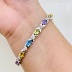 PRODUCT INFO :                   Stone : Natural Blue Topaz / Peridot / Amethyst / Citrine Stone size : 4x6MM oval Accent Stone : Cubic Zircon Metal type : Sterling silver (92.5) Approximate weight :  13 grams ADDITIONAL INFO : ~ Every product consist of 925 stamp. ~ If you want same product in different Stone / Plating ( gold and rose gold) / different Metal (14 k - 18 k gold ) , feel free to contact me .  ~ If you are in rush and want your pretty jewelry pieces early , we can sent it to express service with extra shipping cost of 15 -20 $ ~ Since we use natural gemstones, the stone may vary slightly in Color, Hue and Reflection. ~ Since all pictures are taken from close it may appear big , read product dimension carefully. ~ We can supply jewelry in bulk , For Wholesale Quantity and Disc Diamond Bracelets With Gemstone Accents For Anniversary, Multi-stone Round Diamond Bracelet For Anniversary, Fine Jewelry Bracelets With Gemstone Accents And Cubic Zirconia, Anniversary Multi-stone Cubic Zirconia Tennis Bracelet, Sterling Silver Cubic Zirconia Gemstone Bracelet, Cubic Zirconia Crystal Gemstone Bracelet, Multi-stone Cubic Zirconia Tennis Bracelet As Gift, Gift Multi-stone Cubic Zirconia Diamond Bracelet, Cubic Zirconia Bracelets With Gemstone Accents Gift