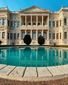 a large building with a pool in front of it