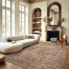 a living room filled with furniture and a large rug on top of a hard wood floor