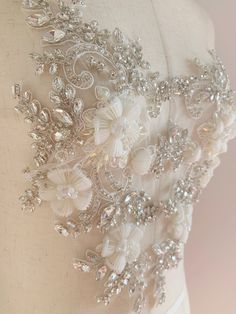 Gorgeous wedding / bridal applique with high quality, genuine crystal rhinestones, crystals, beads, rhinestones and beads are all hand sewn . Delicate bridal applique , dotted with silver rhinestone ,beads , pearls and crystals. with large beads in the center , perfect for bridal sash, belts, wedding accessories, bridal head piece etc size: Price is for one piece. more in stock ~ Please this is only applique, which supposed to be made into belts or sashes after your DIY Check more amazing laces Fitted Rhinestone Bridal Accessories For Party, Fitted Bridal Accessories With Rhinestones For Party, Crystal Bridal Accessories For Wedding, Embellished Fitted Bridal Belt, Fitted Bridal Accessories With Pearl Embroidery For Wedding, Crystal Bridal Accessories With Rhinestones For Bride, Fitted Embellished Bridal Accessories For Party, Embellished Fitted Bridal Belt For Wedding, Fitted Embellished Bridal Belt For Wedding