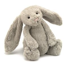 a gray stuffed rabbit sitting up against a white background