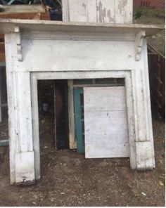 two old wooden cupboards sitting next to each other in front of a tree and building