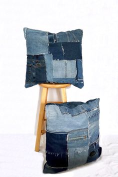 two denim pillows stacked on top of each other