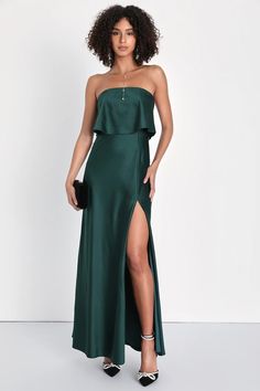 a woman wearing a green dress with high slit