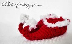 a knitted red shoe with white trim on the bottom and feet, sitting in front of a white background