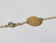 "Simple. Chic. Minimalist™ Super cute initial bracelet for your little daughter. Also a great gift! A brilliant CZ diamond (zirconia) charm and one tiny 14k gold filled tag (11mm), stamped with your choice of comic-font upper-case initial. The 14k gold filled Rollo chain (superb quality) is sparkly and delicate yet very sturdy. All components are 14k gold filled! Bracelet available in the following sizes: 4\"-4.5\" (4\" with half-an-inch of extension chain) 0-1 years old 4.5\"-5\" (4.5\" with ha Gold Hypoallergenic Name Bracelet, Hypoallergenic Gold Bracelets For Bridesmaids, Gold Name Bracelet For Birthday, Hypoallergenic Gold Name Bracelet For Birthday, Gold Name Bracelet With Birthstone For Birthday, Custom Name Gold Bracelet For Bridesmaids, Personalized Gold Name Bracelet As Bridesmaid Gift, Personalized Gold Charm Bracelet For Bridesmaid Gift, Gold Custom Name Bracelet For Bridesmaids