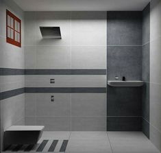 an empty bathroom with grey and white walls