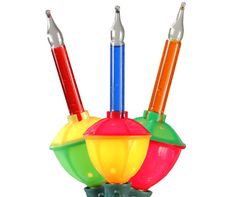 three different colored lights in a holder on a white background