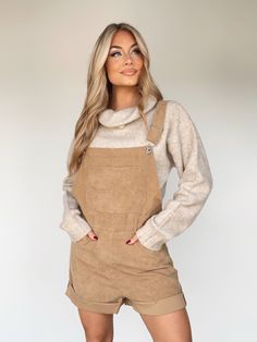 Experience sophisticated style with our luxurious Corduroy Shortalls. Crafted from soft and sumptuous corduroy, the classic square neckline and neatly folded hem exude refined elegance. Enjoy pocket details, adjustable straps, and subtle button closure details for all-day comfort and cosy transitions from summer to fall. Layer up and experience the perfect pumpkin patch to apple picking piece for an elevated and trendy look. 98% Polyester 2% Spandex Hand wash cold. Fall Corduroy Overalls For Workwear, Fall Corduroy Workwear Overalls, Winter Corduroy Overalls, Fall Overalls With Adjustable Straps, Fitted Bib Front Overalls For Fall, Fall Overalls With Suspenders For Workwear, Fall Workwear Overalls With Suspenders, Fall Workwear Shortalls, Chic Overalls With Pockets For Fall