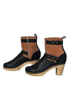 Go for some boho style with a boot that is oh-so-stylish! Made with a clog design, these two-toned beauties from Loeffler Randall are sure to bring in some height and '70s style to any outfit, from maxi dresses to your favorite flared jeans. Size 9 (EU 39) Leather upper Side zipper closure Clog style with wooden platform and heel Rounded toe with stitching Leather interior with no signs of wear Man-made sole with very little wear Heel 3" Boot shaft 5" Fall Boots With Wooden High Heel, Fall High Heel Boots With Wooden Heel, Fall Ankle Boots With Wooden Heel, Chic Fall Boots With Wooden Heel, Ankle-high Boots With Wooden Heel For Fall, Fall Boots With Wooden Heel And Closed Toe, Black Boots With Wooden Heel And Round Toe, Brown Boots With Wooden Heel For Fall, High Heel Clogs For Fall, Medium Width