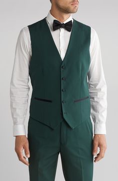 Bring understated elegance to the table in this three-piece tuxedo crafted from rich fabric in a classic single-breasted silhouette. Jacket has shawl collar; chest welt pocket; front welt pockets Vest has front button closure; V-neck Pants have zip fly with button closure; front slant pockets; back button-welt pockets Jacket and vest are lined; trousers are lined to the knee 65% polyester, 35% viscose Dry clean Imported Fitted Green Three-piece Suit For Party, Fitted Sleeveless Tuxedo Set, Elegant Sleeveless Fitted Tuxedo, Formal Fitted Suiting Fabric Sets, Fitted Three-piece Suit For Work, Fitted Three-piece Suit For Semi-formal Occasions, Fitted Suiting Fabric Sets For Formal Occasions, Formal Fitted Sets In Suiting Fabric, Elegant Sleeveless Three-piece Suit For Semi-formal Occasions