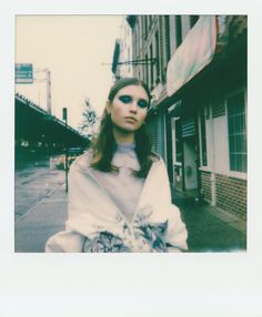 a woman standing in front of a building