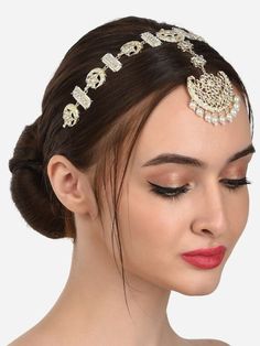 a woman wearing a head piece with pearls