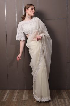 Off-white chinon saree with floral, thread and sequins hand embroidery. Comes with a padded blouse. - Aza Fashions Elegant White Tissue Silk Pre-draped Saree, Designer Bollywood Pre-draped Saree In Off White, Off White Georgette Pre-draped Saree For Reception, Elegant White Pre-draped Saree For Eid, Designer Off White Saree With Sheer Dupatta, Designer Pre-draped Off White Saree With Sheer Dupatta, White Dola Silk Pre-draped Saree For Wedding, White Chanderi Pre-draped Saree With Zari Work, Off White Designer Pre-draped Saree For Festive Occasions