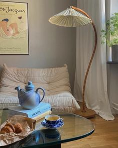 a living room with a couch, coffee table and lamp on it's side