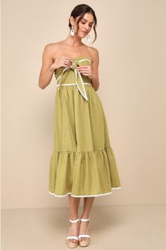 Everyone will be asking where you shop when you're wearing a darling look like the Lulus Delightful Design Light Green Polka Dot Midi Dress With Pockets! Gauzy woven cotton-blend fabric, with a white polka dot-inspired design throughout, shapes a strapless bodice with hidden no-slip strips, a sweetheart neckline, and a tying front detail with rickrack trim. Fitted waist tops a tiered skirt with side seam pockets that falls to a midi hem. Hidden zipper/clasp at back. Fit: This garment fits true to size. Length: Mid-calf length. Size medium measures 40.75" from top to bottom. Bust: Great for any cup size. Waist: Fitted - very fitted at natural waist. Hip: Not Fitted - fuller skirt allows room for hips. Undergarments: May be worn with a strapless bra, adhesive bra, petals, or no bra. Fabric: Polka Dot Summer Dress For Picnic, Polka Dot Dresses For Summer Picnic, Chic Cotton Dress For Picnic, Chic Polka Dot Cotton Dress, Chic Cotton Polka Dot Dress, Polka Dot Cotton Sundress, Cotton Polka Dot Sundress, Cotton Sundress With Polka Dot Pattern, Spring Graduation Dress