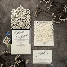 the wedding stationery is laid out on the ground