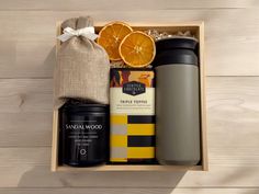 an open box containing coffee, oranges and other items