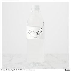 a bottle of water sitting on top of a marble counter with the words we do written on it