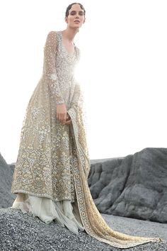 Beige Wedding Dress With Intricate Embroidery, Elegant Embellished Net Sharara, Elegant Beige Embellished Sharara, Elegant Embellished Beige Sharara, Elegant Embellished Net Gown, Elegant Wedding Sharara With Sequins, Elegant Sequin Sharara For Wedding, Glamorous Beige Wedding Gown, Elegant Net Gown With Resham Embroidery