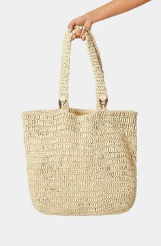 The Billini Ocean Tote Bag is the perfect companion for beach trips. This chic and stylish bag is made of natural raffia and is perfect for storing all your beach day essentials. With its large size and comfortable handles, it is a great bag for a relaxed day at the beach. Beachy Sand-colored Beach Bag With Braided Handles, Chic Summer Bags Made Of Natural Fiber, Chic Beach Bag Made Of Natural Fiber, Chic Bags With Adjustable Strap For Beach Season, Chic Beach Season Bags With Adjustable Strap, Trendy Natural Straw Bag With Adjustable Strap, Sand-colored Bags With Braided Handles For Daily Use, Eco-friendly Bags With Adjustable Strap, Eco-friendly Bag With Adjustable Strap And Natural Fiber