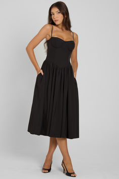 Introducing our Ballerina Bustier Midi Dress - a classic, feminine dress option for any occasion. From brunch parties to evening events, this black bustier midi dress is complimented with wire bustier cups that skim down to a tight fit that cinches at the waistline. The skirt silhouette features a gathered detail that falls to a midi length making it an elegant dress meant to last in your wardrobe forever. Brunch Parties, Bustier Midi Dress, Classic Feminine, Black Bustier, Fall 24, Bustier Dress, Feminine Dress, Corset Dress, Black Midi Dress