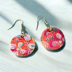 These earrings are one of a kind hand painted paper earrings with cute flower embelishments.  They have a little golden touch around the edges.  They are coated with quality UV resin. Very light weight!  Earrings come with high quality nickel free hypoallergenic earring hooks. Unique Hand Painted Flower Drop Earrings, Artistic Flower-shaped Earrings For Gifts, Artsy Hand Painted Flower Earrings, Bohemian Hand-painted Resin Earrings, Bohemian Hand Painted Resin Earrings, Handmade Artsy Flower Earrings, Artistic Multicolor Flower Earrings, Artistic Hand Painted Flower Earrings, Bohemian Hand Painted Flower Earrings