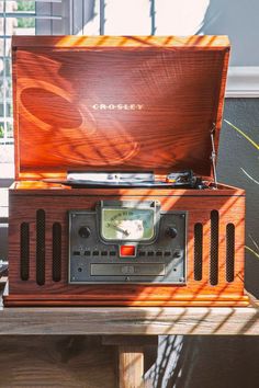 an old fashioned radio sitting on top of a wooden table