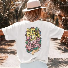 Embrace nature and groovy vibes with our "Life is Better with Plant Medicine" back-printed t-shirt. This trendy tee features a bold message and a unique retro design, perfect for expressing your love for natural remedies. Made from soft, high-quality cotton, it offers a comfortable and flattering unisex fit. Choose your favorite color t-shirt and spread positive, plant-powered vibes wherever you go! 💚 Material: 100% Cotton (fiber content may vary for different colors) Fabric Weight: Medium  Fit Hippie Tops With Funny Print For Spring, Spring Hippie Top With Funny Print, Hippie Top With Funny Print For Spring, Bohemian Letter Print Summer Tops, Hippie Crew Neck T-shirt For Music Festival, Hippie Crew Neck Top For Music Festival, Bohemian Graphic Print Tops For Music Festival, Bohemian Relaxed Fit T-shirt With Letter Print, Hippie Style T-shirt With Letter Print