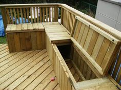 a wooden bench sitting on top of a wooden deck