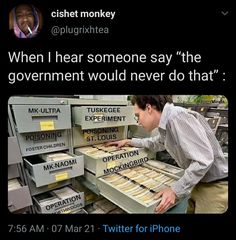 a man is looking at some boxes that are stacked on top of each other