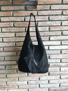 LARGE tote leather bag in dark BLACK. Natural genuine SUEDE leather. NOT LINED. We added a small leather zipper pouch for your mobile phone and/or cards or money. It ist attached to the inside of the bag by a metal chain. The bag is closed by a metal clip at the center. Width : 42cm - 16,5 in Height at the center: 34 cm - 13, 5 inc Total height : 65,5 cm - 26 inch This bag in different colors and other leather Bags by Good Times Barcelona: https://www.etsy.com/shop/goodtimesbarcelona?section_id= Evening Suede Hobo Bag With Soft Leather, Soft Suede Leather Evening Shoulder Bag, Evening Shoulder Bag With Suede Lining, Rectangular Suede Shoulder Bag With Textured Leather, Suede Bucket Bag With Removable Pouch, Suede Bucket Shoulder Bag With Removable Pouch, Travel Bags In Textured Suede Leather, Suede Evening Bag, Evening Suede Bag