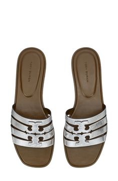 A dimensional Double-T logo stands out atop the strappy vamp of this breezy leather slide sandal. Leather upper and lining/rubber sole Imported Luxury Slip-on Slides For Spring, Tan Leather Footbed Slip-on Sandals, Luxury Slide Mules For Spring, Luxury Spring Slide Mules, Classic Tan Slip-on Sandals, Luxury Summer Slide Mules, Silver Slides With Leather Footbed, Silver Leather Sandals With Flat Heel, Designer Slide Sandals With Cushioned Footbed