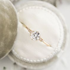 a diamond ring sitting on top of a white cloth