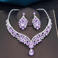 a necklace and earring set with purple stones