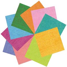 a pile of colored papers sitting on top of each other with different shapes and colors