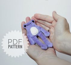 a person holding a purple stuffed animal in their hand with the caption pddf pattern