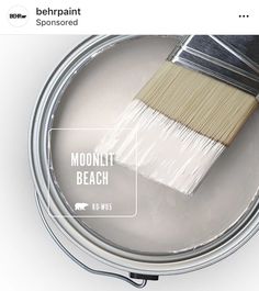 a paint can with a brush in it and the words moonlit beach painted on it