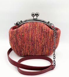 "Red Leather/Fabric Handbag in a Kiss Lock metal frame and with decorative chain is a fashionable  must have in your collection. The combination of Leather and Tweed Fabric makes it unique. The small Women's Handbag is perfect for every day. This Kiss Lock Closure Bag is one of a kind.  Both sides of the bag can be used, Leather and Fabric. Beautiful Cotton lining and two pockets inside. Perfect for your cell phone, wallet, makeup and keys. Ready to Ship. 100% Handmade BAG MEASUREMENTS Height: 7 Red Clutch Evening Bag With Removable Pouch, Red Clutch Evening Bag With Detachable Strap, Red Crossbody Box Bag For Evening, Red Pouch Evening Bag With Detachable Handle, Red Clutch Evening Bag With Detachable Handle, Red Evening Clutch With Detachable Handle, Red Clutch Evening Bag With Chain Strap, Red Evening Bag With Mobile Phone Holder, Red Evening Clutch With Chain Strap