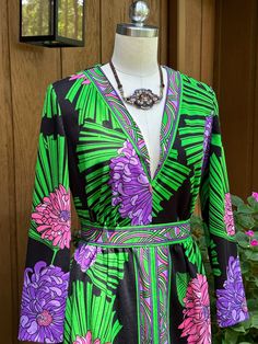 Thank You If You Favored One of My Items! You Will Receive 10% Off an Item of Your Choice, Unless It Is On Sale, Code17. Thank You. LOVELY 70's FLORAL MAXI DRESS/Floral Dresses/Floral Maxis/70's Maxi Dress/70's Dresses/Parkshirt Original Dress/Mint Condition This is a Lovely Circa 70's Floral Maxi Dress.  It has a V Neck, Long Sleeves, and is Maxi in Length.  It is Styled Similarly to an EMILIO PUCCI from the 60's with the Borders Around the Neck, the Waist, and down the Middle Front.  The Flowers are Huge and done in Pink and Purple.  It is Highlighted with Green Leaves. Measurements - Bust - 40"                               Shoulder width - 14.5"                               Sleeve length - 21.5"                               Waist - 29"                               Hips - 38" Retro Dresses With Bold Print For Spring, Retro Spring Dresses With Bold Print, 70s Inspired Long Sleeve Floral Print Dresses, Vintage V-neck Dress With Retro Print, 1970s Green Floral Print Dress, 1970s Style Green Floral Print Dress, 1970s Style Green Long Sleeve Dress, 1970s Green Long Sleeve Dress, Maxi Dress Floral