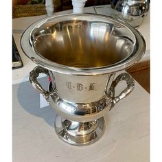 a silver cup sitting on top of a table