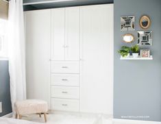 a bedroom with blue walls and white furniture