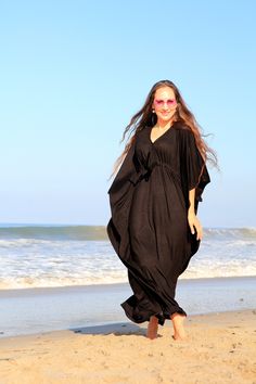 Summer travel is a breeze when your go-to dress is a maxi kaftan in super soft, rayon jersey knit fabric. Add metallic sandals and sparkly jewelry to get glam in a snap, or try it with earthy accessories for the perfect bohemian summer look. Subtle side slits from the knee down, keep movement in this kaftan easy and the fabric flowing. Available in a rainbow of colors. Fit: -Available in sizes: S ( 2-4), M (6-8), L (10-12) , XL (14-16) , XXL (18-20) See image 5 for size chart and color swatches. V-neck Maxi Dress For Beach Season Loungewear, Flowy Black V-neck Beach Dress, Casual Maxi Dress For Beach Season Loungewear, Elegant Flowy Maxi-length Cover-up, Black Maxi Dress For Beach, Elegant Batwing Sleeve Maxi Dress For Summer, Rayon Maxi Length Kaftan, Black Flowy Rayon Maxi Dress, Black Beach Dress With Batwing Sleeves