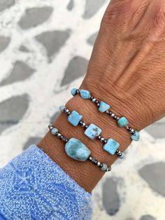 These stunning bracelets feature genuine sky blue Barahona Larimar nuggets, renowned for their captivating blue hues reminiscent of the tropical color of Caribbean sea!  ▽▲Details▽▲ ⭐AAAA sky blue Larimar nuggets 16-17mm ⭐AAAA Cube rectangle nuggets 7mm ⭐AAAA Freeform nuggets 5mm ⭐Smooth polish finish ⭐Silver mineral graphite beads (tarnish free) ⭐Clever fastening to secure perfect fit ⭐Adjustable length ⭐Allergy free/Nickel free ⭐Waterproof use ⭐Handmade excellency Larimar is a rare blue copper Adjustable Aquamarine Bracelets With Natural Stones, Aquamarine Turquoise Bracelet For Healing, Spiritual Aquamarine Turquoise Bracelets, Spiritual Turquoise Aquamarine Bracelets, Turquoise Aquamarine Healing Bracelet, Handmade Adjustable Aquamarine Bracelet, Turquoise Aquamarine Beaded Bracelets As Gift, Handmade Adjustable Larimar Bracelets, Handmade Blue Amazonite Beaded Bracelets