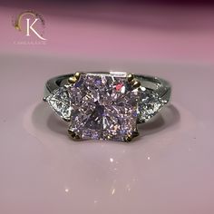 a fancy diamond ring with three stone accents