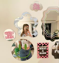 a woman taking a selfie in front of a mirror with various mirrors on the wall