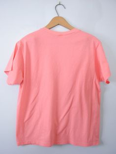 One vintage 1990's plain peach pink tee shirt, men's size small * Crew neckline. * Plain shirt. * Color scheme: pink with peach tones / salmon. | CONDITION | A+. Gently used vintage item. | BRAND | Fruit of the Loom. Made in Honduras. | SIZE | Marked as a child's Large (USA). Fit would be similar to a men's Small or XSmall. PLEASE compare the measurements below to a similar item that fits you for the best sizing! ~ Garment laying flat. Double measurements where applicable. ~ Shoulder width: 15.5 Peach Short Sleeve T-shirt For Summer, Peach Relaxed Fit Crew Neck T-shirt, Peach Relaxed Fit Short Sleeve T-shirt, Casual Peach Short Sleeve T-shirt, Heather Peach Short Sleeve Graphic Tee, Heather Peach Relaxed Fit Crew Neck T-shirt, Heather Peach Relaxed Fit Short Sleeve Top, Casual Peach T-shirt Relaxed Fit, Heather Peach Short Sleeve Relaxed Fit Top