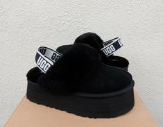 UGG FUNKETTE BLACK FLUFF SLIPPER PLATFORM SANDALS ~ NEW IN BOX WOMEN'S SIZE US 6/ EUR 37/ UK 4 ~ FITS US 6-6.5/ EUR 37-37.5/ UK 4-4.5  STYLE # 1113474  COLOR: BLACK ~MY ITEMS ARE ALWAYS AUTHENTIC, PLEASE SEE MY TRUSTED FEEDBACK Both indoor and outdoor use Suede uppers with sheepskin collar Sheepskin lining Sheepskin insole Stretch UGG logo heel strap 2 " EVA sole ( Fluffy insole add's a bit extra height) Please see the pictures for more detail Inside size tag and box upc have been marked to prev Ugg 2022, Ugg Funkette, Surfer Shoes, Pretty Sneakers, Air Shoes, Black Uggs, Black Slippers, Nike Air Shoes, Ugg Black